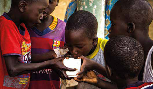 Children drinking water from kiosk