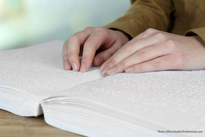 Woman reading book in Braille